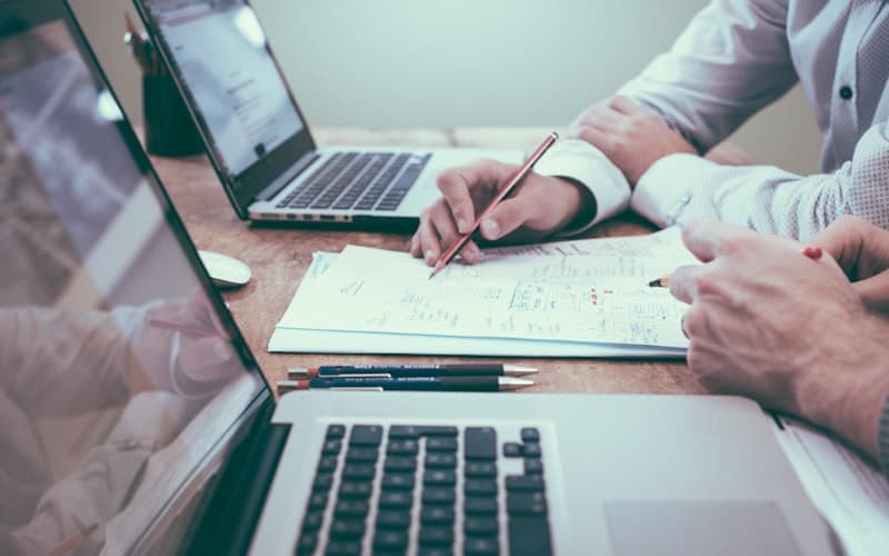 Reviewing documents and negotiating terms at a desk